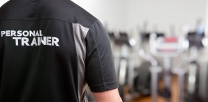 Personal Trainer, with his back facing the camera, looking at a gym